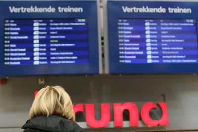 Rear view of woman with text written on airport