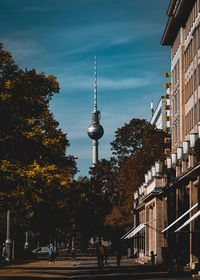 Street light by building against sky