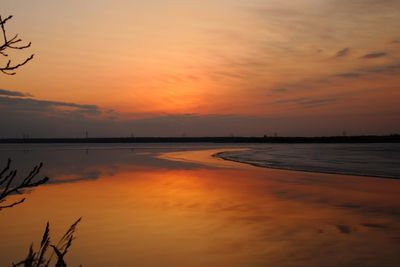 Scenic view of sea against orange sky