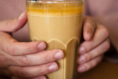 Close-up of hand holding drink