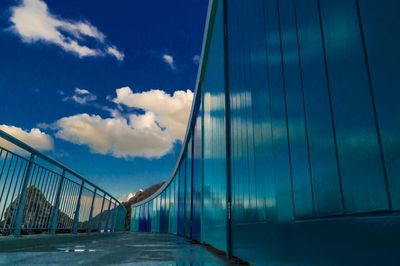 Bridge against cloudy sky