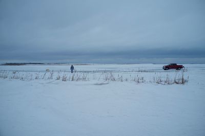 Man on snow field against sky