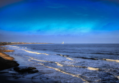 Scenic view of sea against blue sky