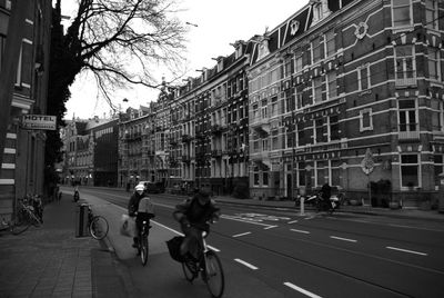People riding bicycles of city street