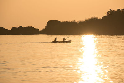 Silhouette of people at sunset