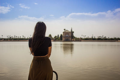 Rear view of woman standing against sky