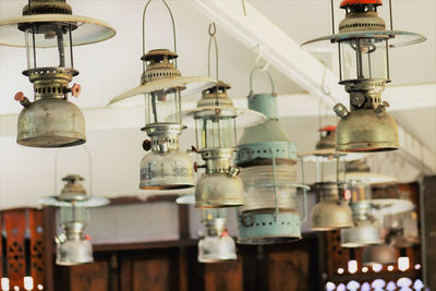 Close-up of antique lanterns hanging in store