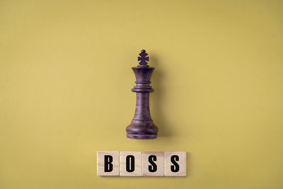 Close-up of trophy against yellow background