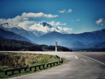 Empty road with mountains in background