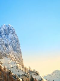 Scenic view of snowcapped mountains against clear blue sky