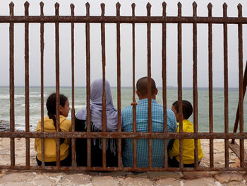 People sitting on railing