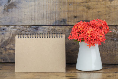 Close-up of vase and calendar on table