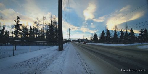 Panoramic view of road against sky during winter