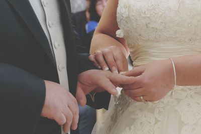 Midsection of couple holding hands