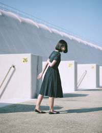 Woman walking on street during sunny day