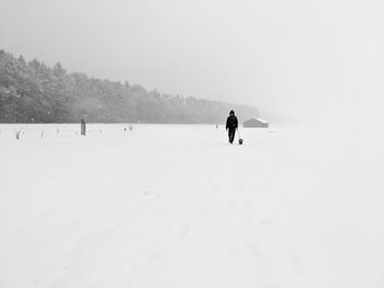 Man on snow covered land