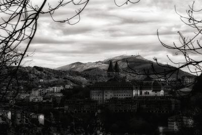 Buildings in town against sky