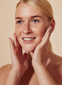 Close-up of young woman against wall