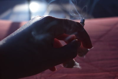 Close-up of cigarette in hand
