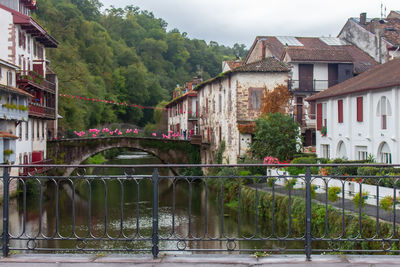 Medieval town with bridge and river. canal and ancient houses with flowers.