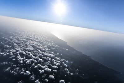 Scenic view of mountains against sky on sunny day