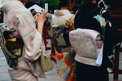 Rear view of people standing in temple