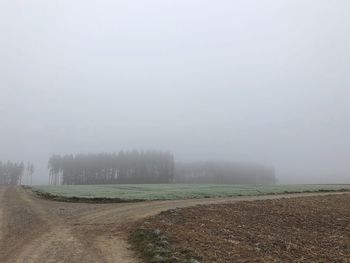 Scenic view of field against sky during winter