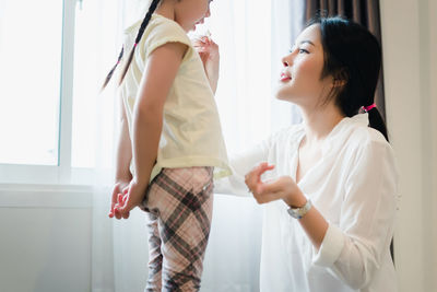 Woman holding hands at home