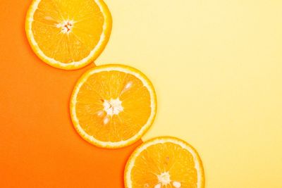 Directly above shot of oranges on yellow background