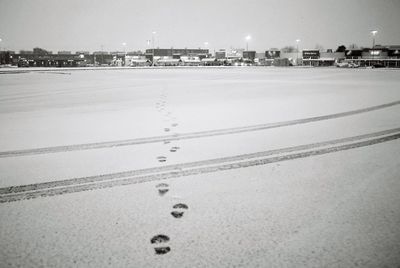 Snow on beach against sky