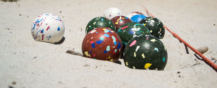 Close-up of multi colored ball on sand