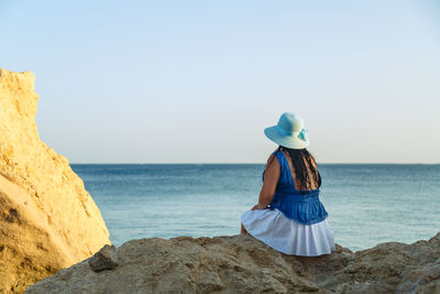 Full length of woman on beach against sky