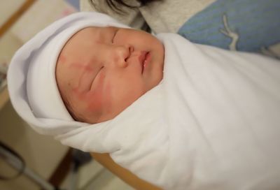 High angle view of baby sleeping on bed at home
