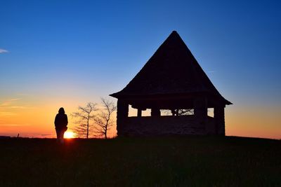 Silhouette of built structure at sunset