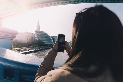 Rear view of woman photographing