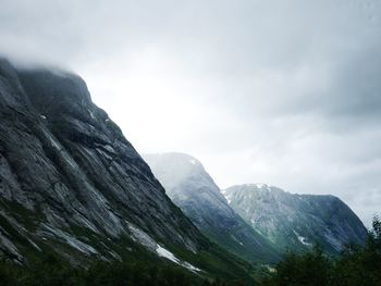 Scenic view of mountains against cloudy sky