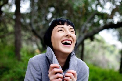 Close-up of a cheerful young woman outdoors