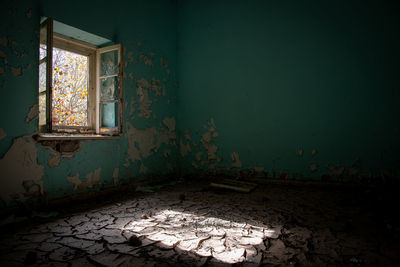 Abandoned house by window at home
