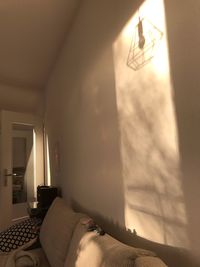 Electric lamp on bed against wall at home