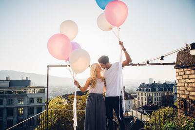 High angle view of people with balloons against sky