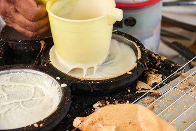 Close-up of person preparing food on table