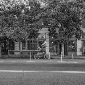 Bicycle on road against building in city