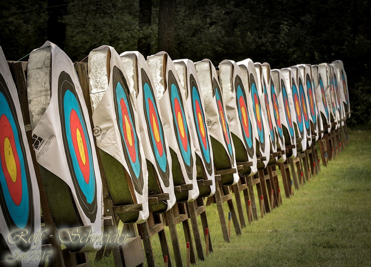 in a row, large group of objects, outdoors, no people, arrangement, day, multi colored