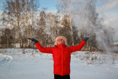 Woman standing on snow covered landscape