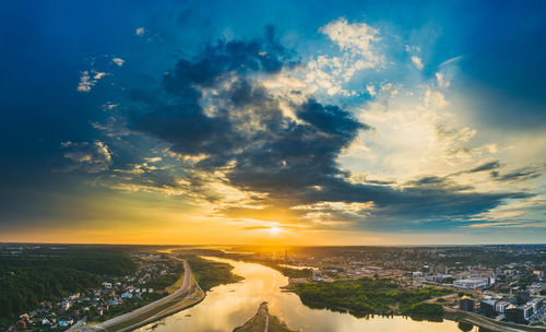 High angle view of road by buildings against sky during sunset