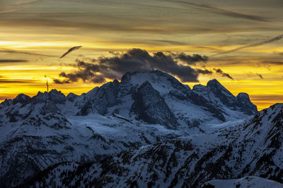 Scenic view of snowcapped mountains against sky during sunset