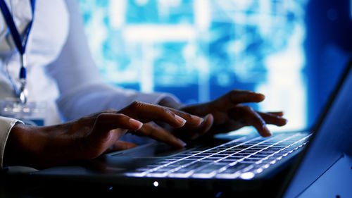 Midsection of man using laptop