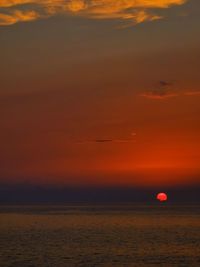 Scenic view of sea against orange sky