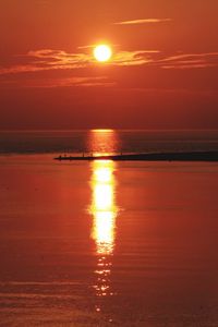 Scenic view of sea against orange sky