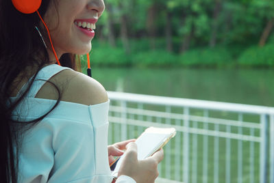 Young woman using mobile phone outdoors